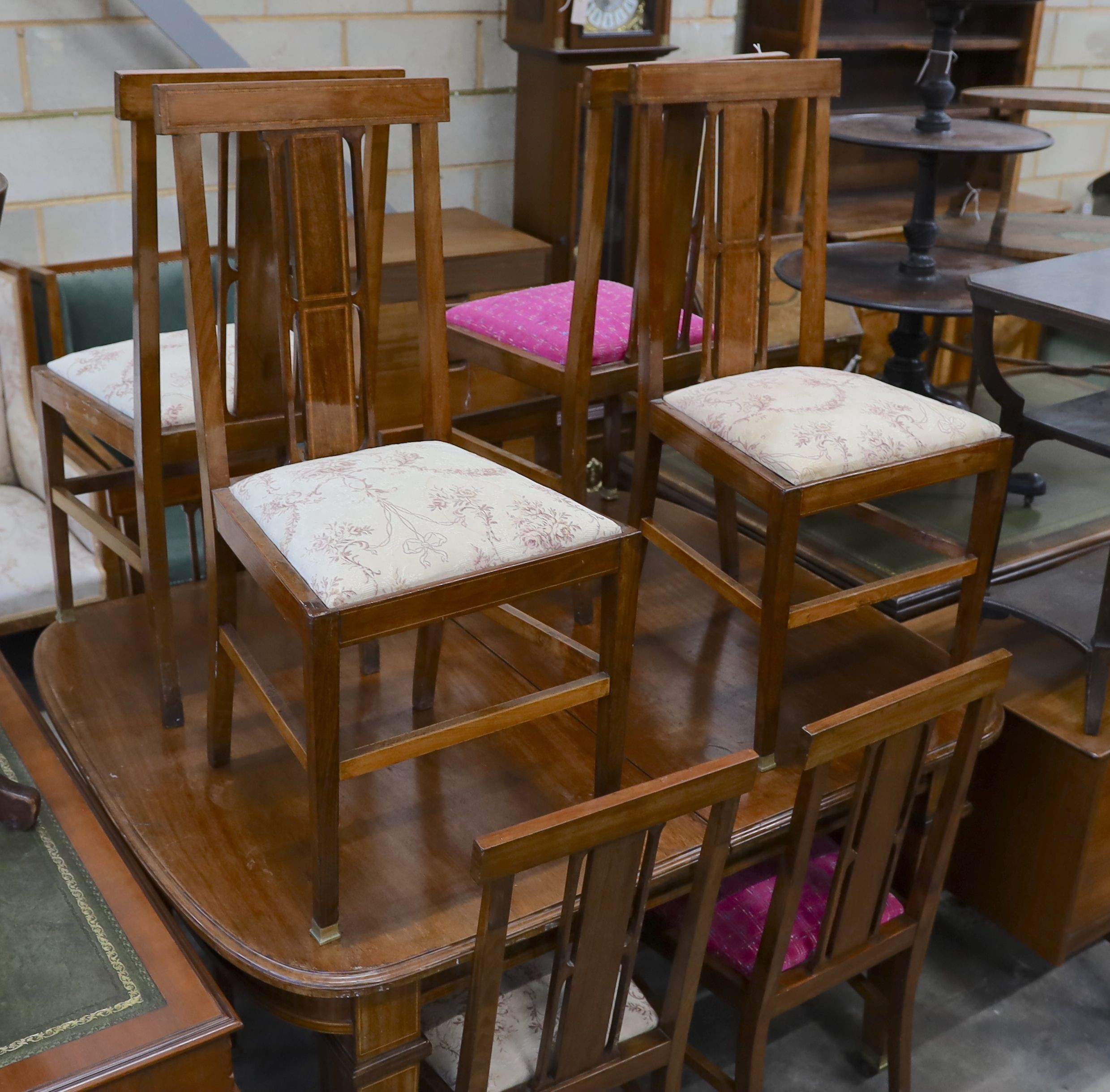 An Edwardian mahogany extending dining table, width 140cm, depth 114cm, height 78cm (no leaves) together with a set of eight Edwardian mahogany satinwood banded dining chairs